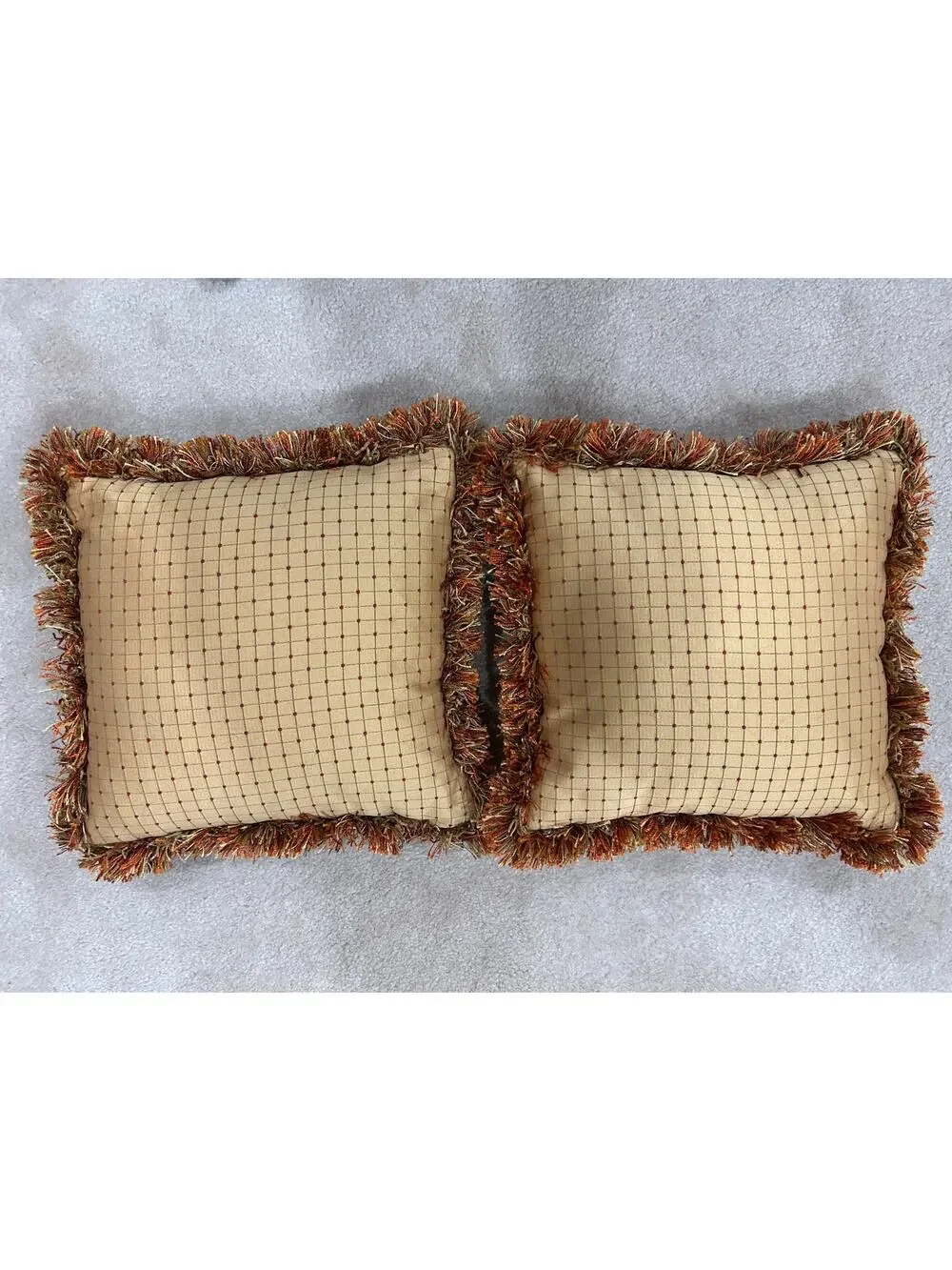 Pair of grid or checkpattern throw pillows orange brown gold